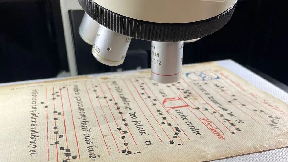 A booklet of 15th century liturgical music, known as an antiphonary, being examined with the Columbia Nano Initiative's Raman spectrometer.