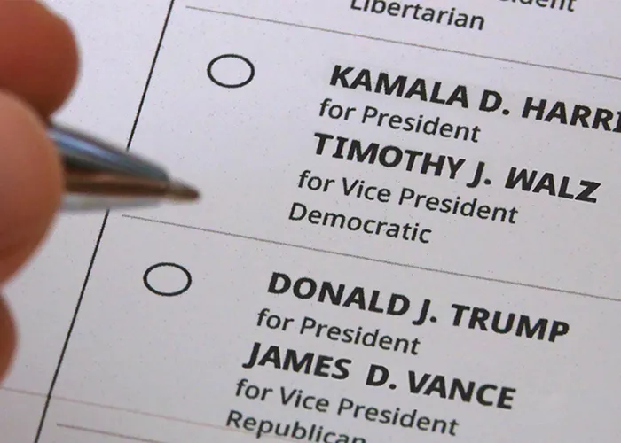 A person fills out a 2024 election ballot