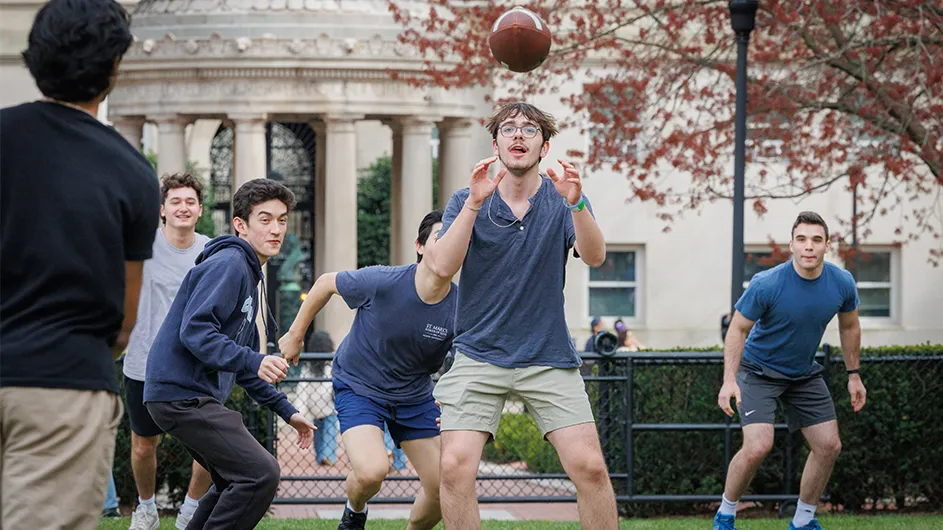 Students throw a football on Columbia's campus