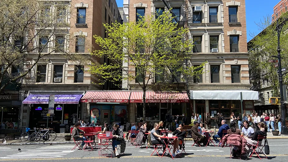 Students sit in front of The Hungarian Pastry Shop in 2022. 