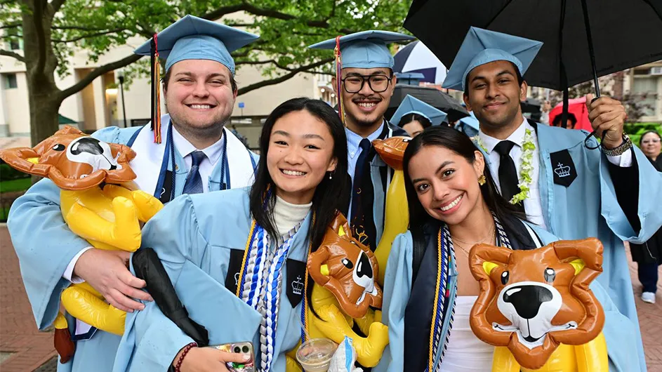 Five gradutes pose on Morningside campus beofre 2025 commencement