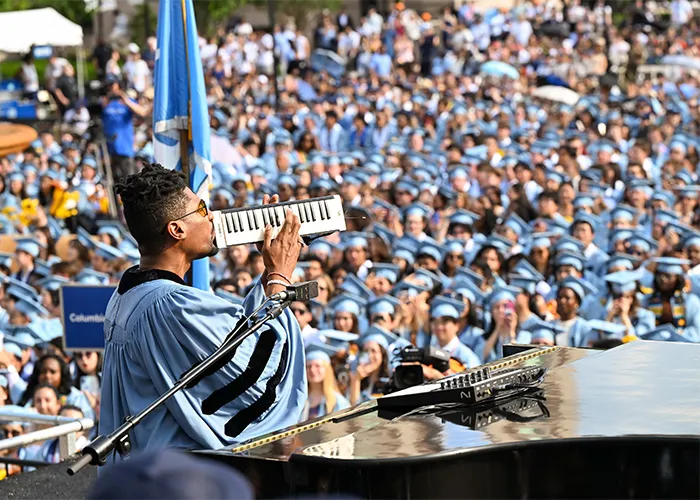 Jon Batiste performs on the melodica at Columbia Commencement.