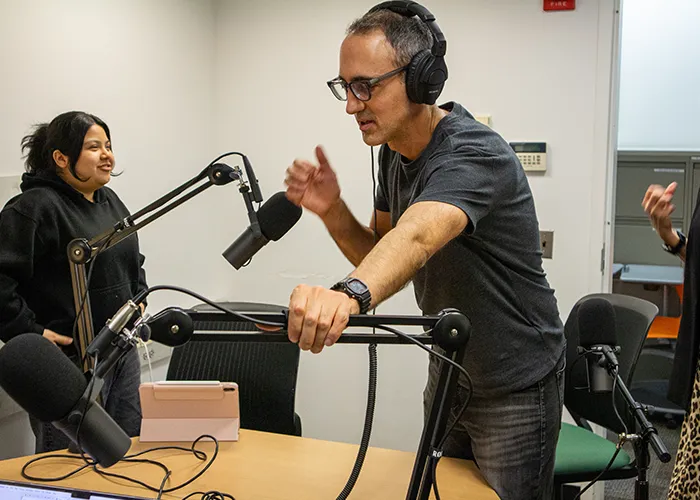 Christopher Kaiser sets up the podcast studio. 