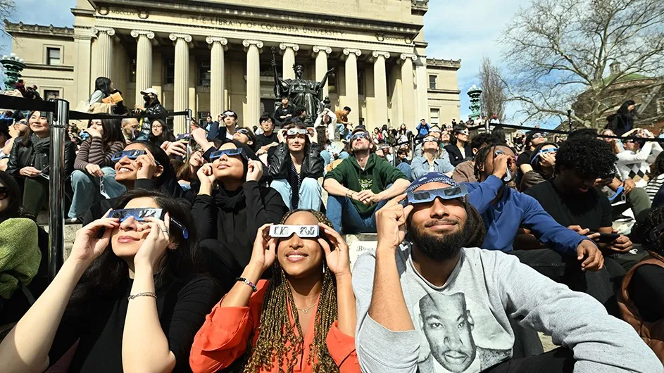 Students look up at the solar eclipse